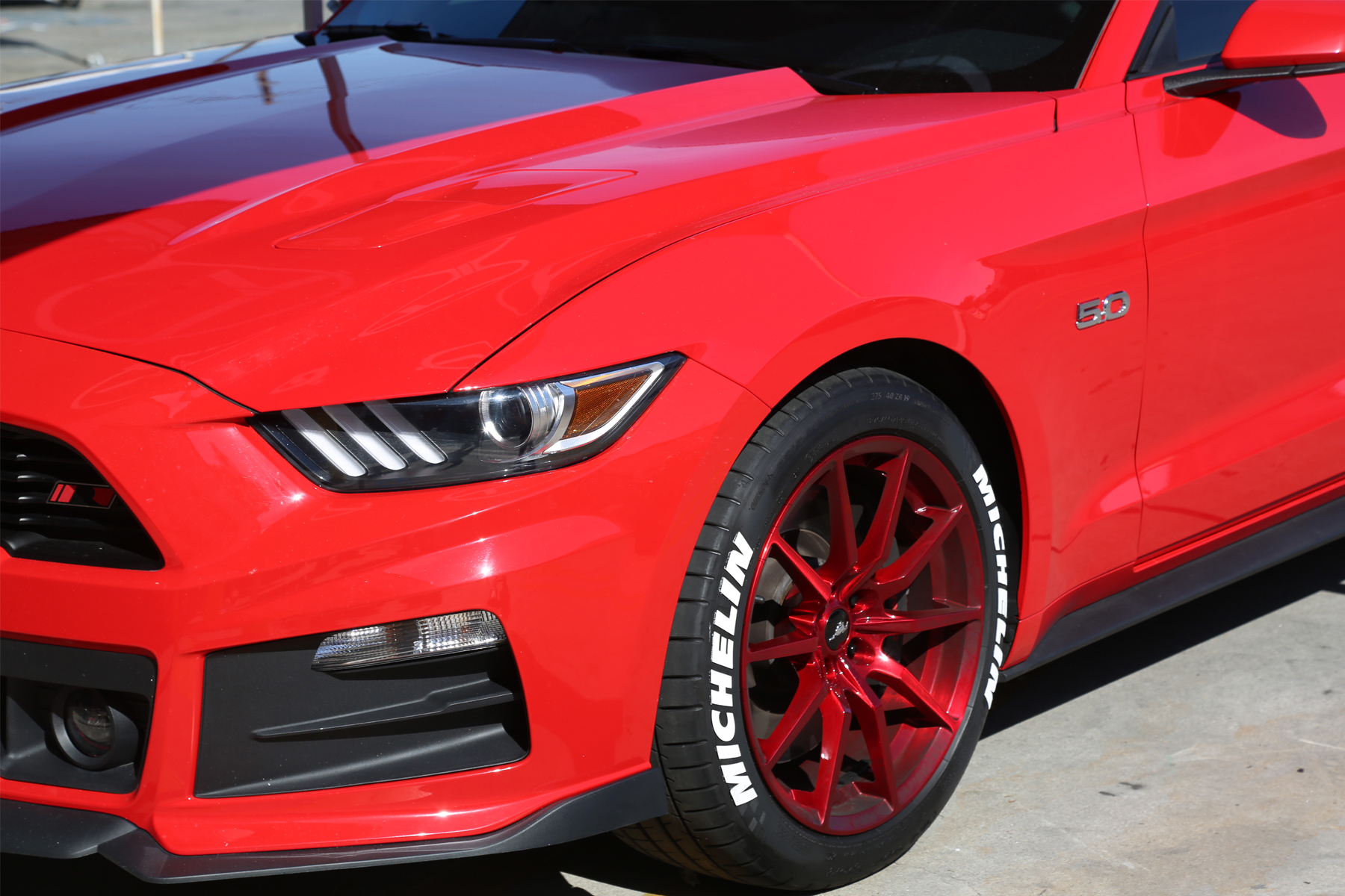white-michelin-tire-stickers-red-ford-mustang-front-side-view.jpg
