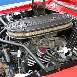 Engine shot. Export brace was stock. Early Cobra Air Cleaner, Monte Carlo Brace added. Cobra Power by Ford valve covers stock. The points have been re