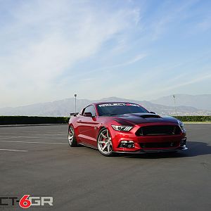 Project 6gr wheels on a Ruby Red Ford Mustang GT Front Side long shot View
